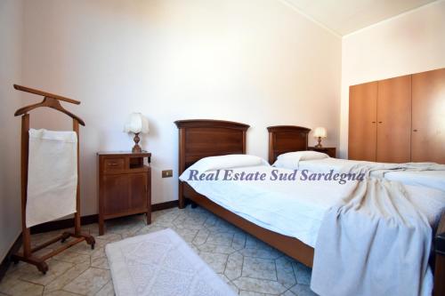 a bedroom with two beds and a wooden dresser at Casa Elena 1 in Pula