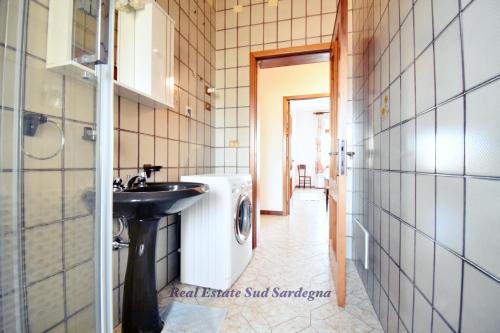 a bathroom with a sink and a washing machine at Casa Elena 1 in Pula