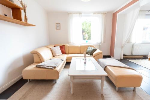 a living room with a couch and a table at Ferienwohnung Stellah in Eyendorf