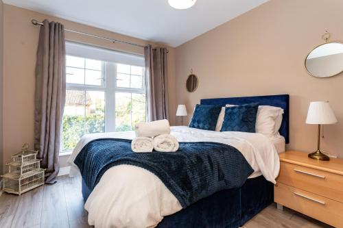 a bedroom with a large bed with towels on it at Slane Stay, Belfast in Belfast
