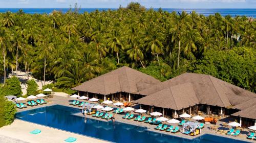 an aerial view of a resort with a swimming pool at Atmosphere Kanifushi - Premium All Inclusive with Free Transfers in Lhaviyani Atoll