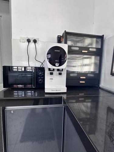 a kitchen with two microwaves and a microwave on a counter at DeCherating privatepool in Cherating