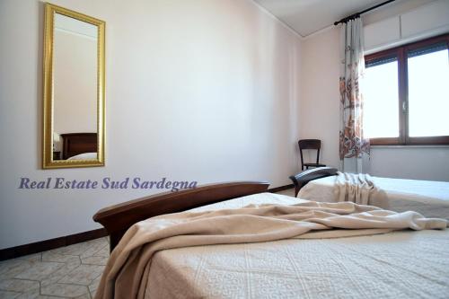 a bedroom with a bed with a mirror and a chair at Casa Elena 1 in Pula