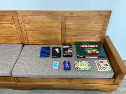 a bed with games and board games on it at Seascape Modern Accomodation Near CLUB MED ALBION in Albion