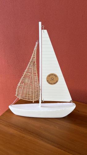 a model boat sitting on top of a wooden table at Seascape Modern Accomodation Near CLUB MED ALBION in Albion