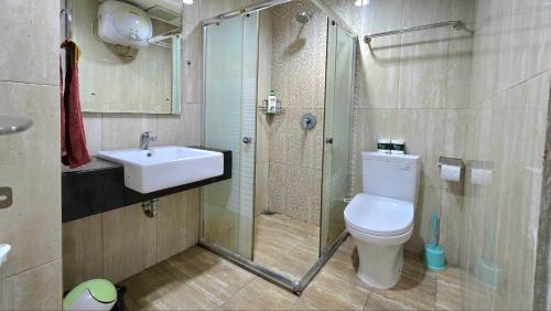 a bathroom with a sink and a toilet and a shower at Trivium Terrace Apartment Lippo Cikarang EJIP -Min Stay 3 Nights- in Bekasi