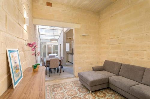 a living room with a couch and a table at Melita Breeze House in Sliema