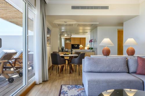 a living room with a couch and a table at Nevo by Isrotel Collection in Ein Bokek