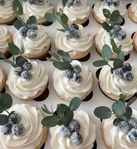 a bunch of cupcakes with white frosting and blueberries on them at Eternity Athens -Opening 2025- in Athens
