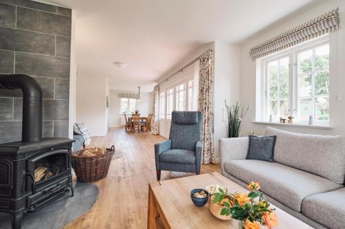 a living room with a couch and a fireplace at Landhaus Markerup in Husby