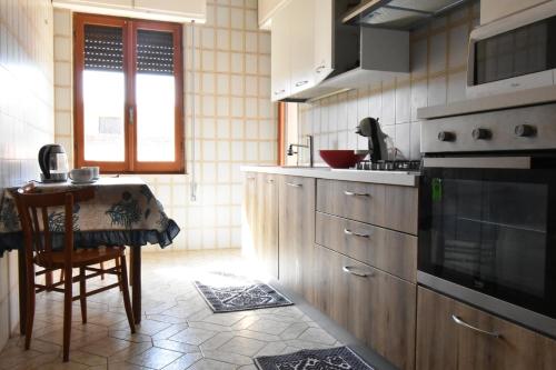a kitchen with a table and a stove top oven at Casa Elena 1 in Pula