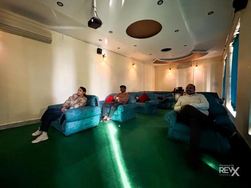 a group of people sitting on couches in a room at The Neeraj River Forest Resort Ayurvedic Wellness Center in Rishīkesh