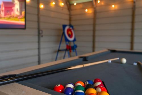 two billiard tables with balls in a room at Lone Star Getaway I Rec Barn I Fire Pit Nights I Movie Night Projector in Fischer