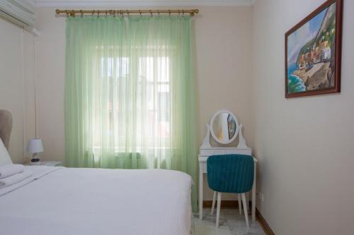 a bedroom with a bed and a mirror and a window at Montesan Luxury Apartment Beach Front in Sveti Stefan