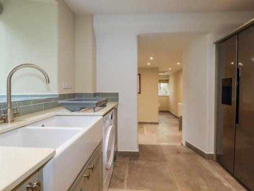 a kitchen with a sink and a dishwasher at Tretoil Farm House in Bodmin