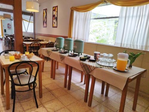 a row of tables with drinks on them in a restaurant at Hotel Corales in Mar del Plata