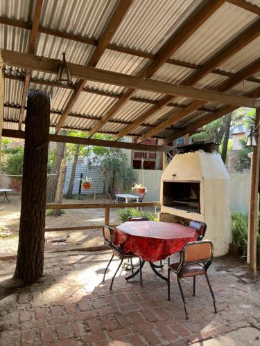 a patio with a table and an outdoor oven at Casa Rústica para 8 personas in Mar Azul
