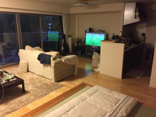 a living room with a white couch and a television at The Rareage Hakone-Yumoto by Mloc in Hakone