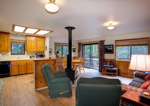 a kitchen and living room with a wood stove at Cecil's Cabin in Wawona