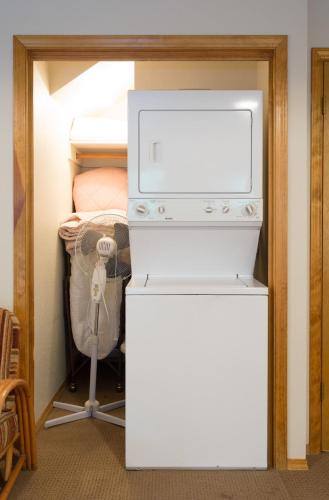 a room with a white stove in a room at Cecil's Cabin in Wawona