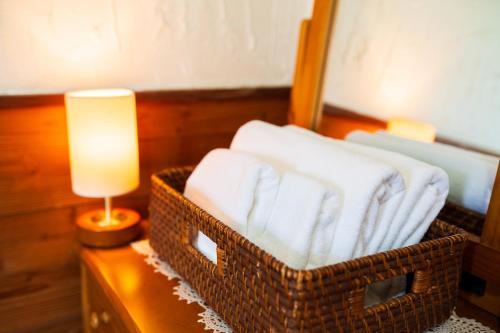 a room with two baskets on a table with a lamp at Pension Yufuin in Yufuin