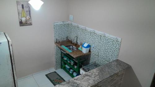 a small bathroom with a sink and a counter at Pousada Rua 35 Na Villa Verde Buzios Rj in Buzios