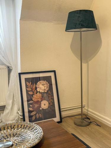 a lamp sitting next to a picture on a table at Charmantes Altbauflair Nordhorn in Nordhorn