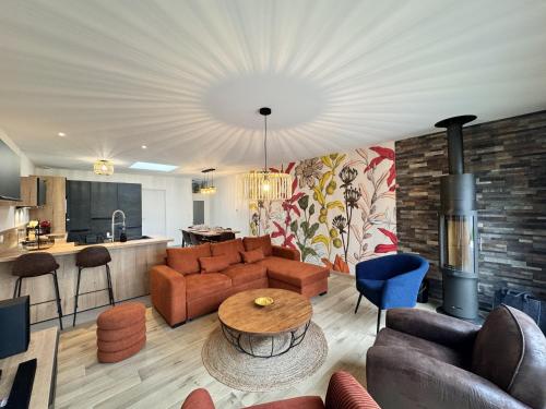 un salon avec un canapé et une table dans l'établissement Le Charme - Jardin - Petanque - Parking - 6p, au Mans