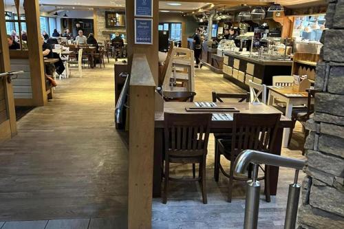 a restaurant with wooden tables and chairs in a restaurant at Charming 5-Beds Caravan in beautiful Seton Sands in Port Seton