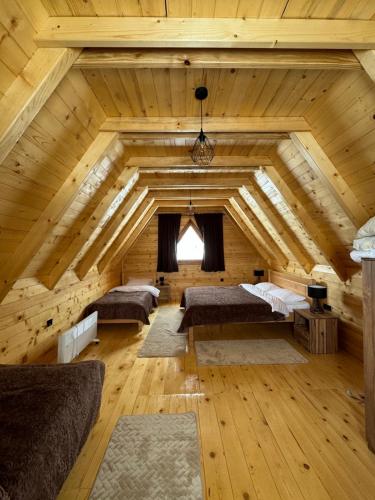a large room with wooden ceilings in a log cabin at Vista Wood in Žabljak