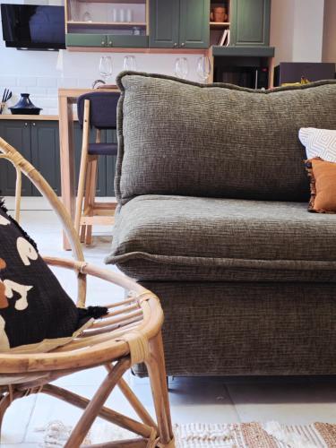 a living room with a couch and a chair at Boho Nest in Rosporden