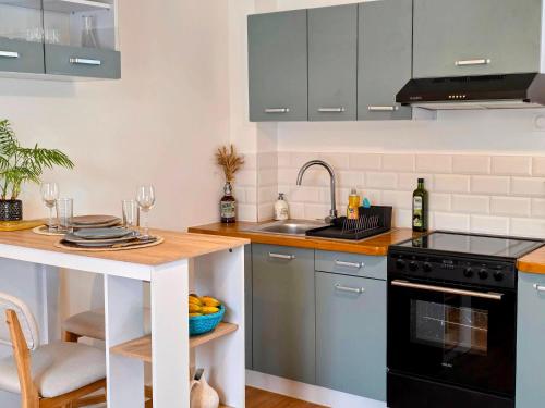 a kitchen with a sink and a stove top oven at Boho Nest in Rosporden
