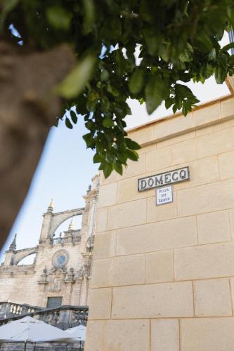 a sign on the side of a building with a clock tower at Hotel Boutique Sidonia in Jerez de la Frontera