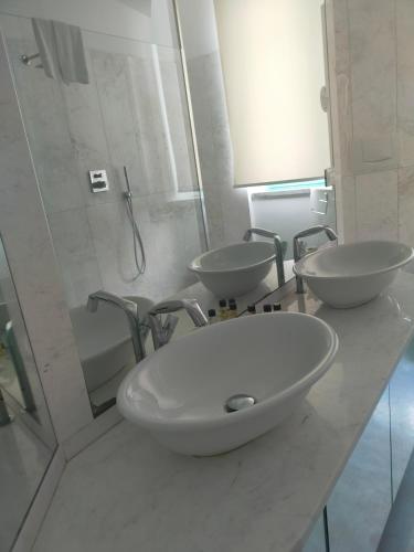 a bathroom with two sinks and a shower at Hotel Excelsior in Vasto