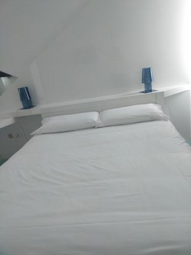 a white bed with two lamps on top of it at Hotel Excelsior in Vasto