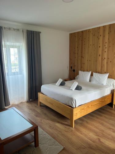 a bedroom with a large bed in a room at Vila Rosario in Ponta Delgada