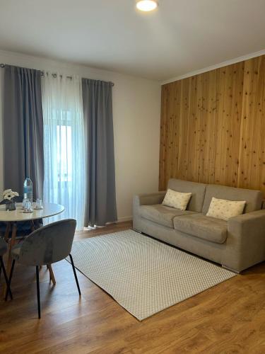 a living room with a couch and a table at Vila Rosario in Ponta Delgada