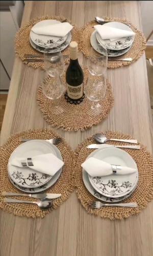 a table with plates and a bottle of wine at Silver Star Zlatibor in Zlatibor