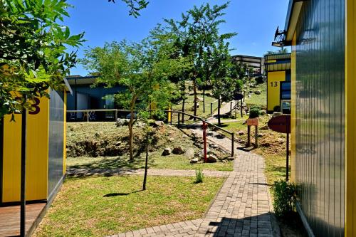 a walkway next to a building with a yard at SleepOver KMIA in White River