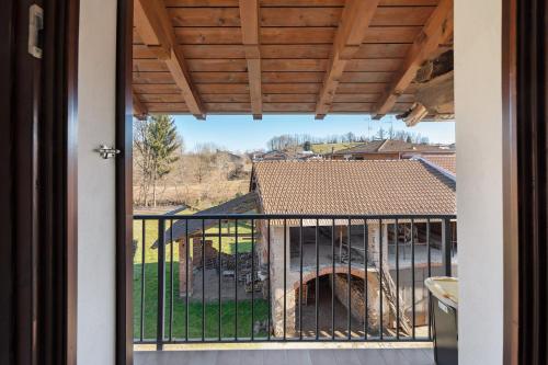 a balcony with a view of a house at L' Antico Fienile in Borgomanero
