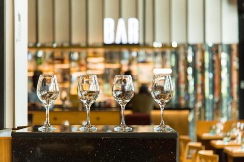 four wine glasses sitting on top of a table at Accra Luxury Apartments at The Edge in Accra