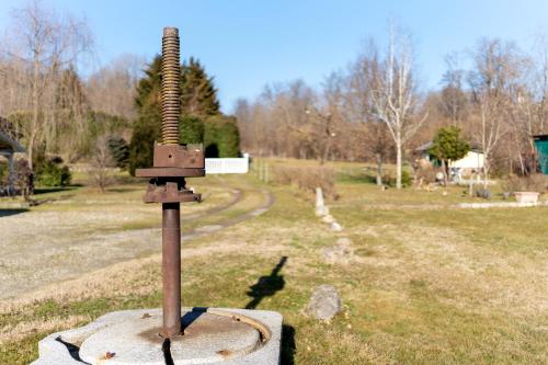 a metal tool sitting on top of a field at L' Antico Fienile in Borgomanero
