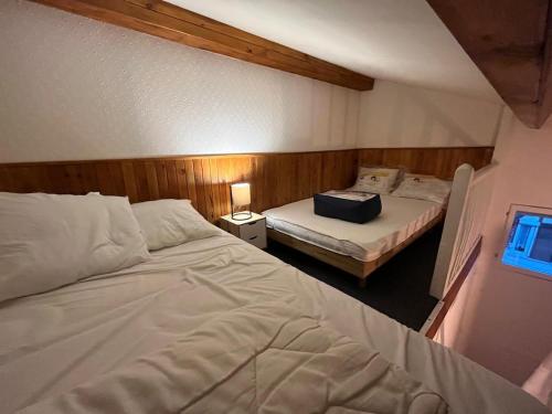 a bedroom with two beds and a window at Au Chant des Mouettes in Cabourg
