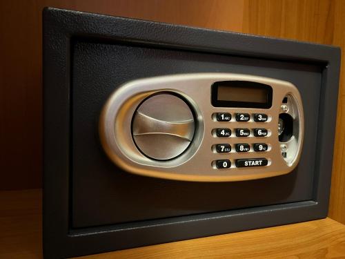 a black and silver microwave oven with a control panel at Hotel ILF in Prague