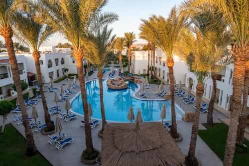 an aerial view of a resort pool with palm trees at Xperience St. George Sharm El Sheikh in Sharm El Sheikh