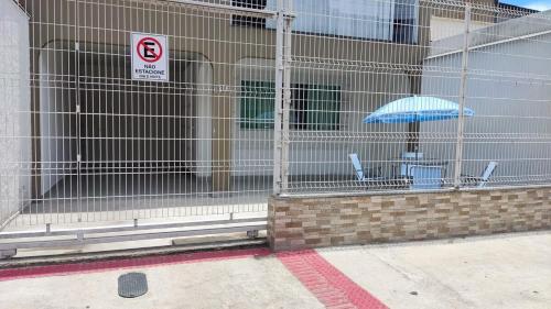 a cage with a table and an umbrella in it at Casa ampla Praia da Costa - Centro 500 mts da Praia in Vila Velha