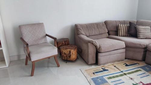 a living room with a couch and a chair at Casa ampla Praia da Costa - Centro 500 mts da Praia in Vila Velha