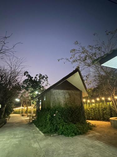 a small building with lights on it at night at Rublom Resort Mae Taeng in Mae Taeng