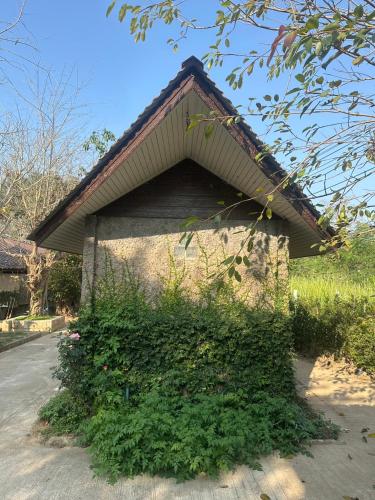 a building with ivy growing on the side of it at Rublom Resort Mae Taeng in Mae Taeng