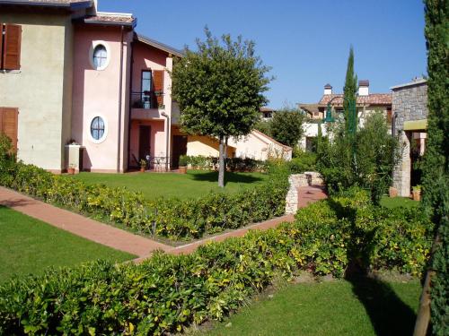 a house with a garden in front of it at Poggio al sole in Manerba del Garda